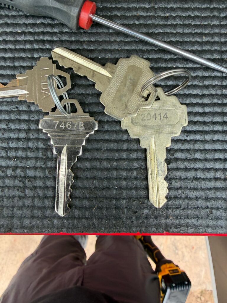 Freshly cut house keys on a locksmith workbench after rekeying a home in Edmond, OK