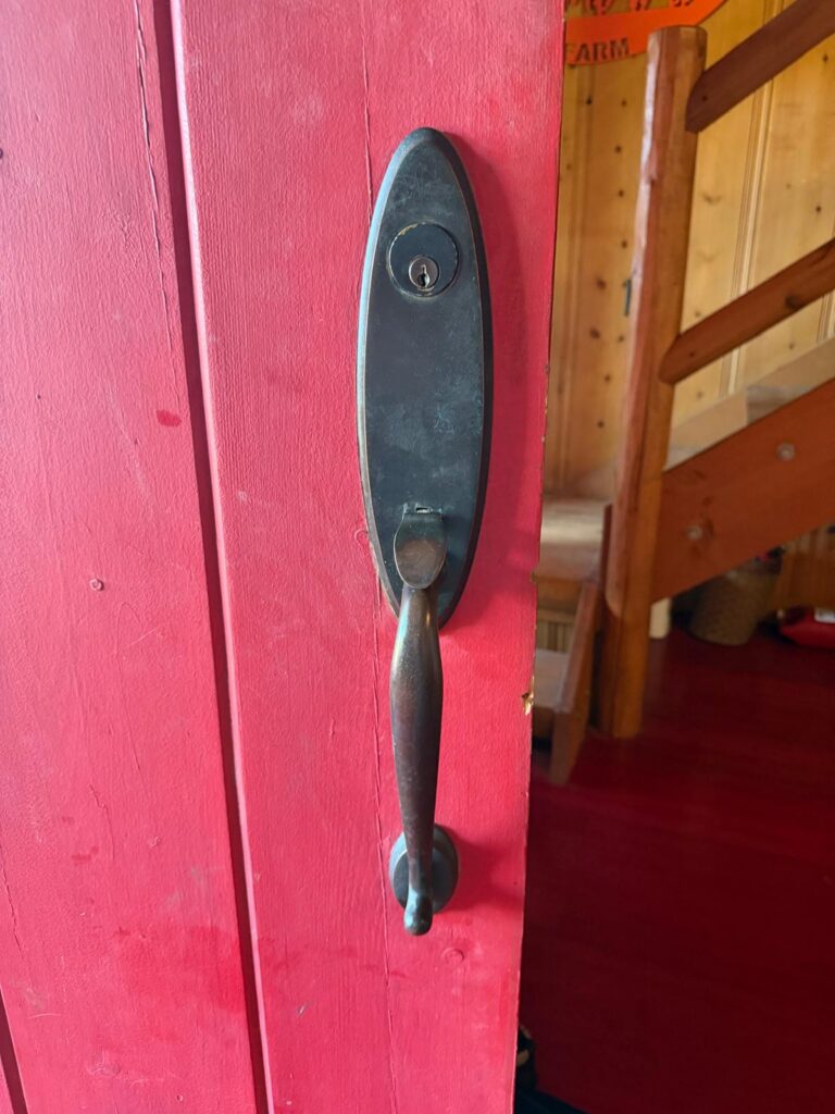 Red front door with an oil-rubbed bronze handleset and keyed deadbolt in Edmond, OK
